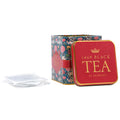 Tea tin with floral design and '1869 Black Tea' text, accompanied by white tea bags.