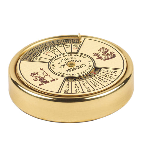 Round brass calendar.