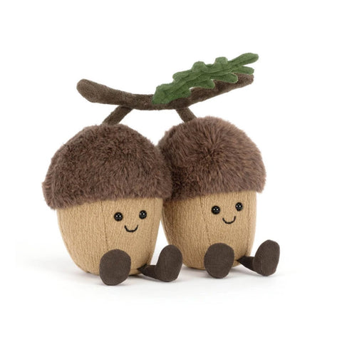 Two plush acorn toys sitting side by side on a white background. Each acorn has a tan body, a fuzzy brown cap, small black eyes, a smiling face, and dark brown feet.