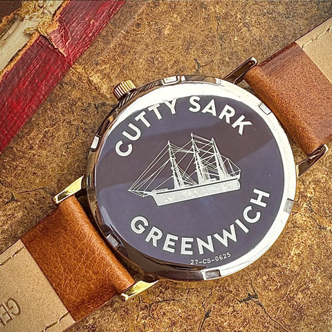 Back of watch case with 'Cutty Sark Greenwich' and an image of the ship etched into it
