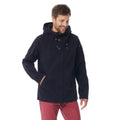 A man wearing a dark navy hooded jacket and red trousers