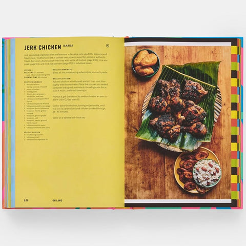 Open book showing a recipe for jerk chicken with a photograph of the dish on a wooden surface.
