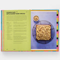 Open cookbook showing a recipe for cashew cake with cashew fudge drizzle.