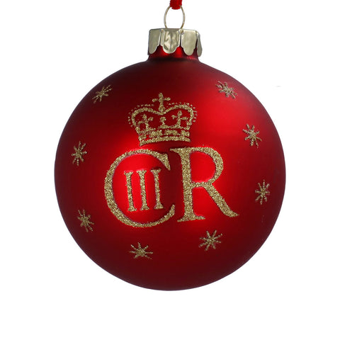 A red glass Christmas ornament featuring a gold glitter crown, the initials 'CR', and Roman numeral 'III' with small gold glitter stars.