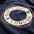 Close-up of a Cutty Sark logo on a dark fabric background