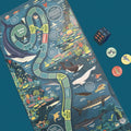 Board game with ocean-themed design, including sharks and marine life, on a blue background.