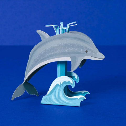 Dolphin-shaped drink mixer on a blue background
