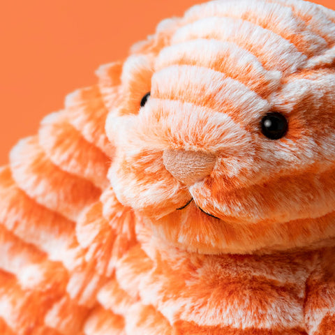 close up image of the face of an orange bunny soft plush toy