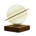 Floating Saturn lamp floating above a wooden base