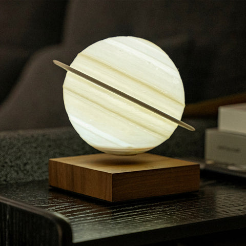 Floating Saturn lamp on dark wood