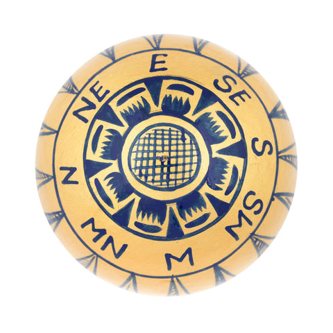 A round bauble decoration featuring a navy blue compass rose design with the cardinal directions (N, NE, E, SE, S, SW, W, MN, M) 