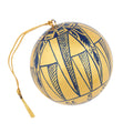 A spherical gold ornament decorated with navy blue geometric and tribal-style patterns, featuring a gold hanging loop and tassel,
