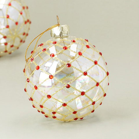 Decorative Christmas ornament with gold mesh and red beads on a light background