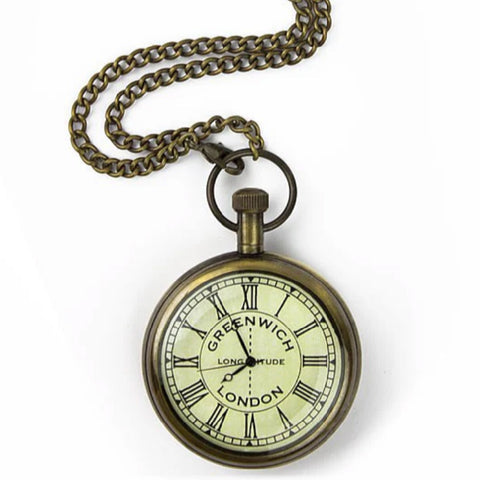 Brass pocket watch with chain and off-white and black face.