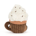 A plush hot chocolate toy shaped like a mug, featuring a fluffy white faux-cream top with small brown sprinkle details, an orange scarf, and a ribbed brown cup with a dark brown handle