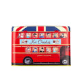 A red double-decker bus-shaped tin filled with hot chocolate, featuring a Union Jack pattern on the roof, illustrated passengers in the windows, and 'London Transport' branding on the side.