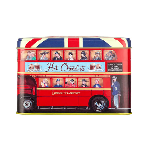 A London double-decker bus-shaped hot chocolate tin featuring red, white, and blue Union Jack styling, illustrated characters from the windows, and 'Hot Chocolate' text on the side, shown on a plain white background.