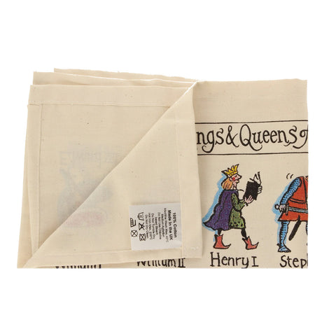 Detail of cotton tea towel with colourful illustrations of kings and queens. 