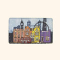 Bar of soap in paper with a colourful cityscape design featuring buildings and a red bus.