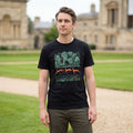 Man wearing a black t-shirt with a graphic design standing in front of a historic building.