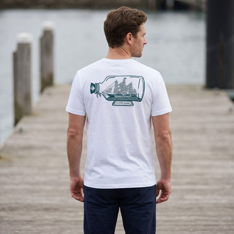 Man wearing a T-shirt with Cutty Sark ship in bottle print on the back