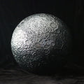Textured sphere resembling a moon on a dark background