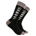A pair of black crew socks with gray cuffs, heels, and toes, featuring a white moon phase graphic and small multicolored speckles