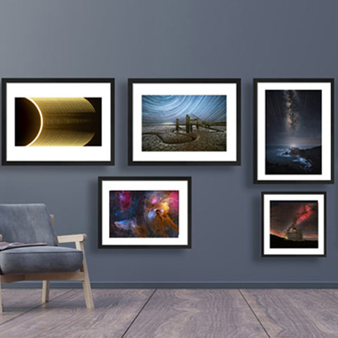 Astronomy Photographer of the year prints displayed on a wall.