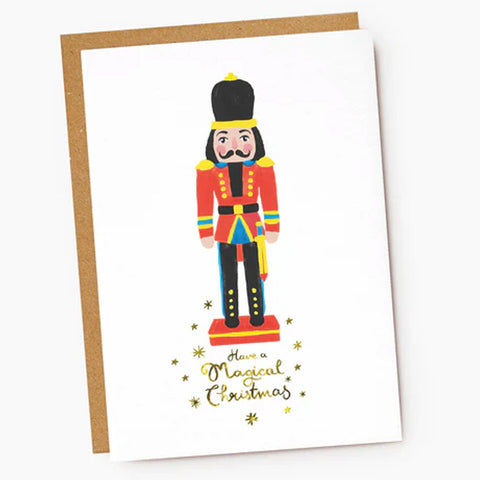 Greeting card with a colorful nutcracker illustration and 'Have a Magical Christmas' text on a white background.