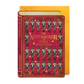 Christmas card with a decorative book with 'The Nutcracker' design on a red background