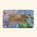 Bar of soap with ocean-themed packaging featuring a turtle, seaweed, and starfish on a blue background.