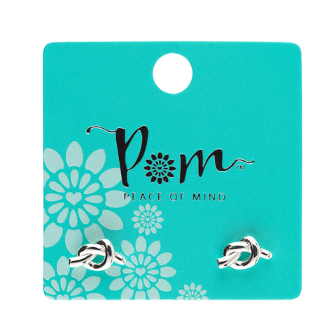Pair of silver knot earrings on a 'Pom' branded card with floral design
