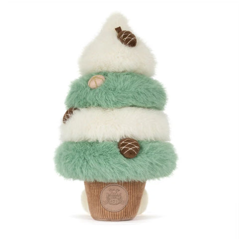 A plush stuffed animal shaped like a tiered tree, featuring mint green and cream faux fur layers, brown accents, and a brown corduroy base with a circular embroidered logo.