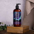 Hand and body wash bottle labeled 'Polar Lights' on a wooden stand with a neutral background