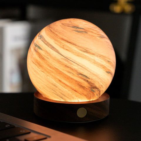 Wooden texture lamp on a dark surface with blurred background