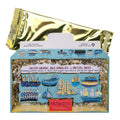 A boxed chocolate product with a metallic gold wrapper partially covering the front of the package. The box is light blue with illustrated ships and boats and a red label reading Artouse Unlimited.