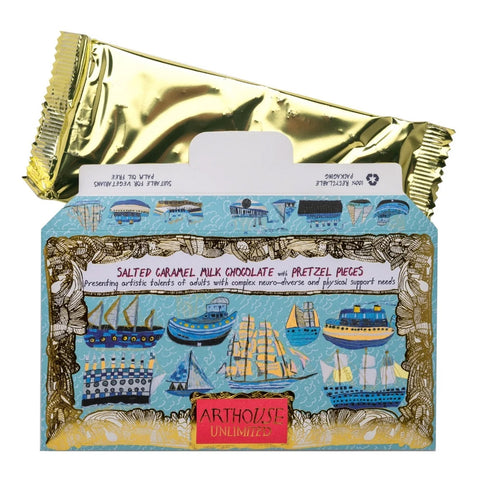 A boxed chocolate product with a metallic gold wrapper partially covering the front of the package. The box is light blue with illustrated ships and boats and a red label reading Artouse Unlimited.
