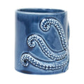 Blue ceramic mug with octopus relief design 