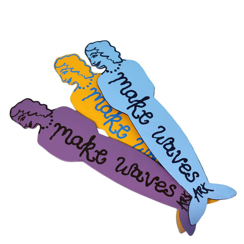 Colourful mermaid-shaped signs with 'make waves' text 