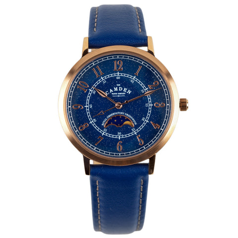 Rose-gold watch with blue face and blue leather strap.