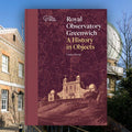 Book titled 'A History in Objects' by Louise Devey with a background of the Royal Observatory Greenwich.