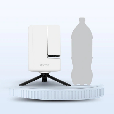 Seestar S30 front view beside 1.5 litre soda bottle against white background