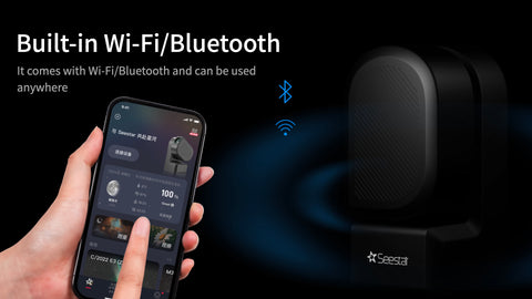 Hand using a smartphone to showcase wifi and blue tooth capabilities of SeeStar S50 seestar astrophotography telescope. Telescope pictured to the right  