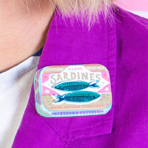 Sardines tin brooch on a purple jacket 
