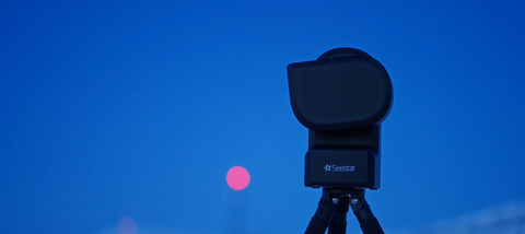 Seestar S50 astrophotography camera telescope against blood moon in sky background
