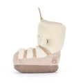 A single mid-calf boot plush toy shown in side profile. The boot features a cream-colored plush fleece collar and trim, a beige suede-like body, beige faux-leather straps, and a brown sole.