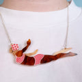 Necklace with a unique pendant of a woman in a swimsuit on a white background