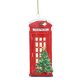 A red telephone booth Christmas ornament decorated with a green Christmas tree, red ornaments, a gold star, and a gold hanging string.