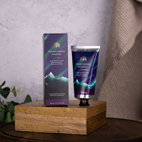 Polar Lights hand cream and packaging on a wooden stand with a neutral background