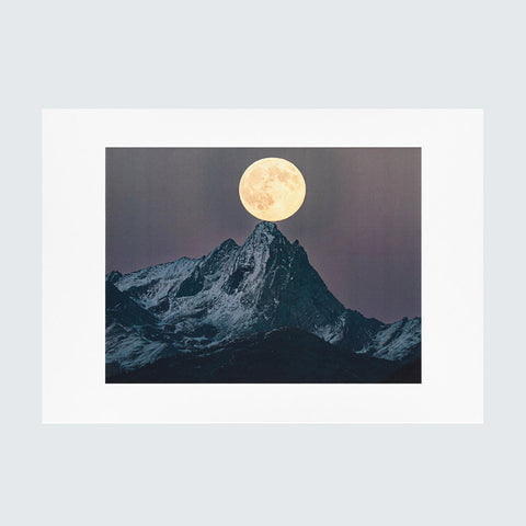 An art print featuring a dramatic mountain peak under a large glowing full moon